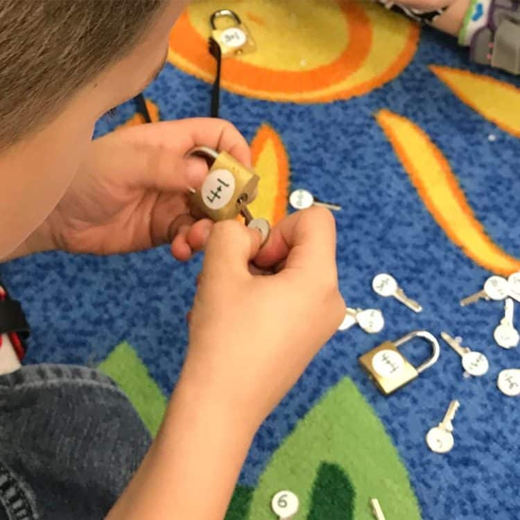 Student using locks and keys in kindergarten