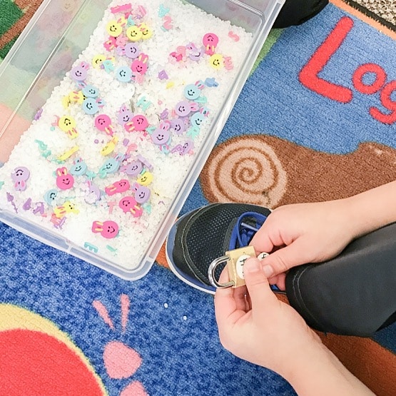 Kindergarten student using lock and keys