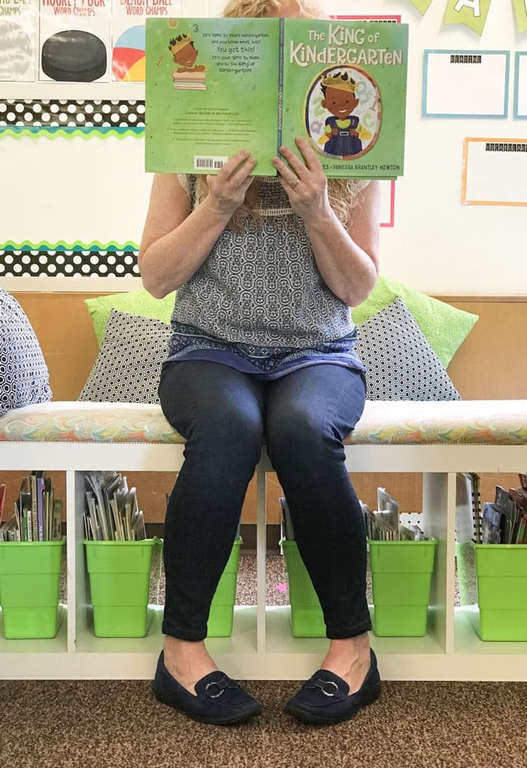 Teacher reading a book wearing EasySpirit loafers.