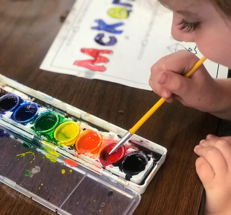 Painting you name in letters and pictures with watercolor paints.