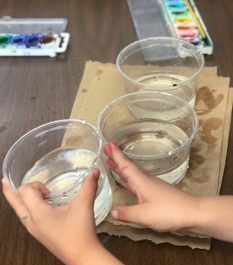 Preparing to paint with water cups.