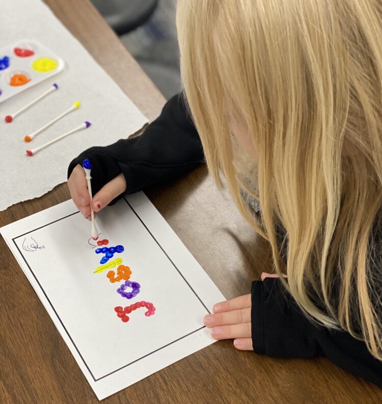 Writing names with q-tips in a kindergarten classroom.