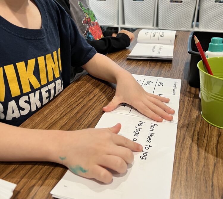 Student reading decodable books.